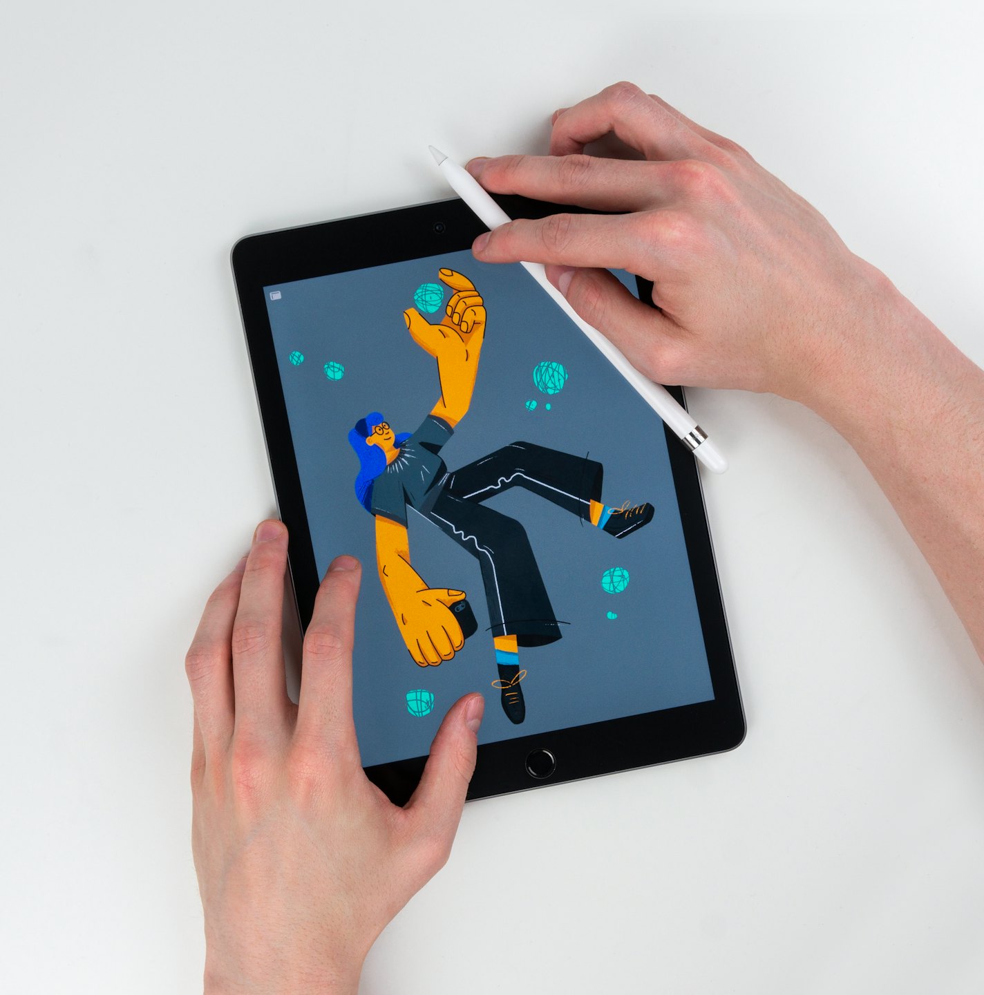 Hands holding a tablet displaying a digital illustration.