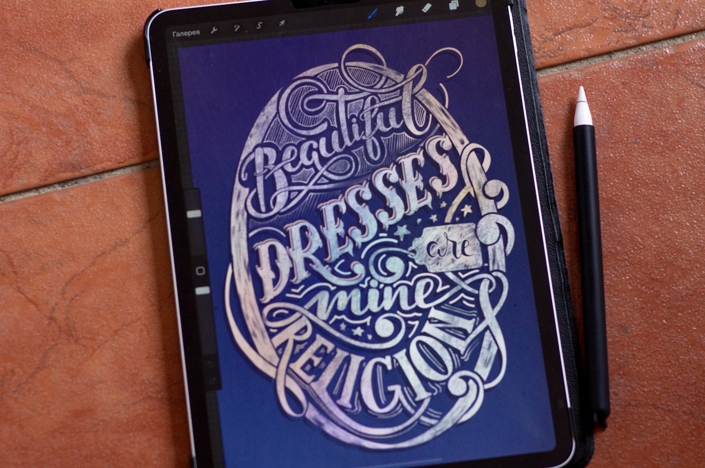 Stylus rests beside a tablet displaying decorative digital lettering.