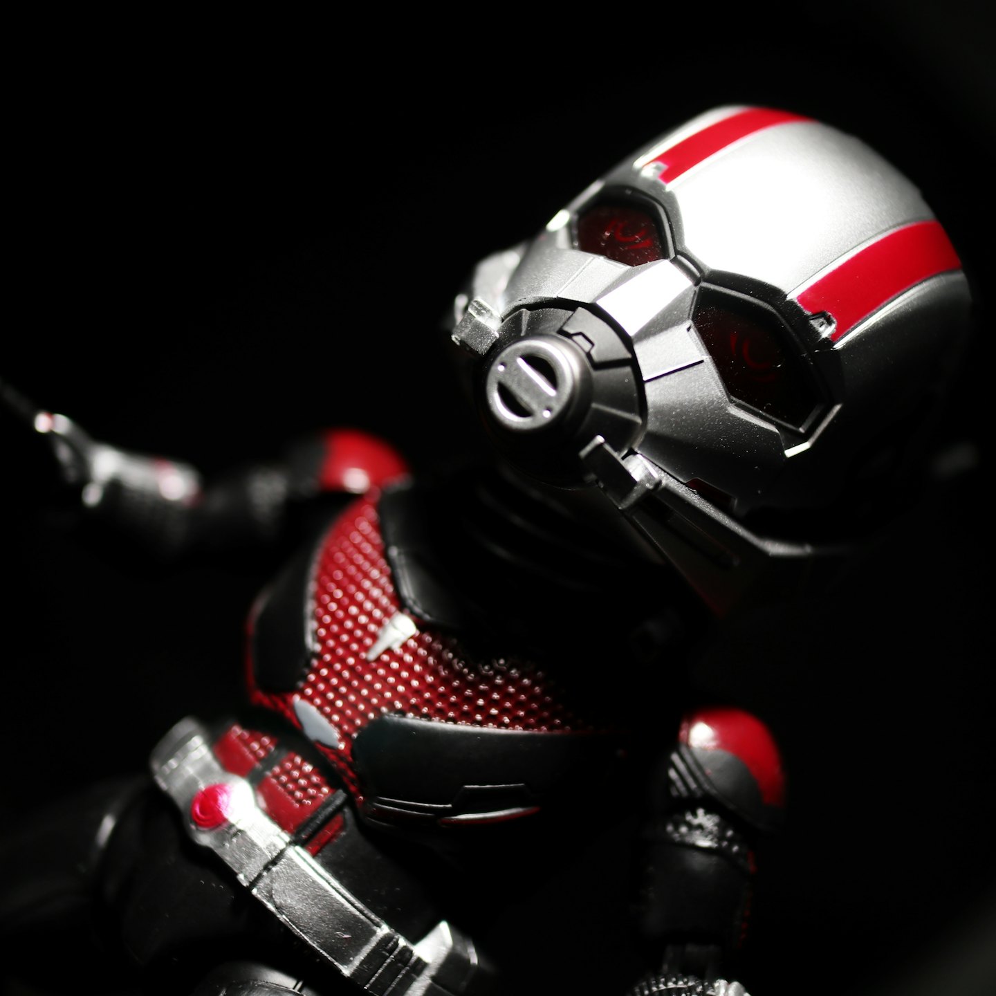 Sci-fi superhero action figure with silver helmet and red stripes.